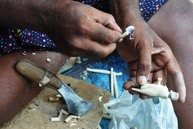 A wooden form being carved by hand